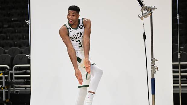 Giannis Antetokounmpo points to his Nike Zoom Freak 4 shoes.